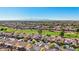 Aerial view of homes, golf course, and mountain range in the background at 22728 N Arrellaga Dr, Sun City West, AZ 85375
