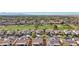 Aerial view of a community with golf course and mountains in background at 22728 N Arrellaga Dr, Sun City West, AZ 85375