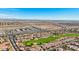 Aerial view showing neighborhood homes, a golf course, and distant mountains at 22728 N Arrellaga Dr, Sun City West, AZ 85375