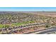 Aerial view of community, golf course, road, and distant mountains at 22728 N Arrellaga Dr, Sun City West, AZ 85375