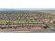 Aerial view of neighborhood adjacent to a golf course and highway at 22728 N Arrellaga Dr, Sun City West, AZ 85375