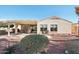 Relaxing covered patio with pergola, comfortable seating, and nicely landscaped desert surroundings at 22728 N Arrellaga Dr, Sun City West, AZ 85375