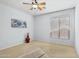 Spacious bedroom featuring a ceiling fan and large window at 22728 N Arrellaga Dr, Sun City West, AZ 85375