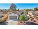 Spanish style home with a two-car garage and landscaping at 22728 N Arrellaga Dr, Sun City West, AZ 85375