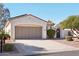 House exterior with a two-car garage and desert landscaping at 22728 N Arrellaga Dr, Sun City West, AZ 85375