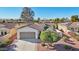 Single story home with a two car garage, solar panels, and a nicely landscaped front yard at 22728 N Arrellaga Dr, Sun City West, AZ 85375
