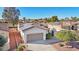 Single-story home with a two-car garage, solar panels, and desert landscaping at 22728 N Arrellaga Dr, Sun City West, AZ 85375