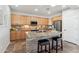 Kitchen features granite countertops, island with seating, and wood cabinets at 22728 N Arrellaga Dr, Sun City West, AZ 85375