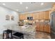 Kitchen boasts granite countertops, large island, and ample wood cabinetry at 22728 N Arrellaga Dr, Sun City West, AZ 85375