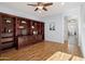 Home office with built-in wooden shelving and hardwood floors at 22728 N Arrellaga Dr, Sun City West, AZ 85375