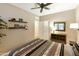 Bedroom with double bed, ceiling fan, and built-in shelving at 24918 S Golfview Dr, Sun Lakes, AZ 85248