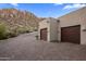 Two-car garage with wood-like doors and paved driveway, set against a mountain backdrop at 25341 N 113Th Way, Scottsdale, AZ 85255