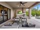 Outdoor kitchen and seating area with a TV, adjacent to the pool area at 25341 N 113Th Way, Scottsdale, AZ 85255