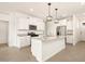 Modern kitchen with stainless steel appliances, a central island, and white cabinets at 2685 E Santa Ynez Dr, Casa Grande, AZ 85194