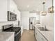 Modern kitchen featuring stainless steel appliances, granite countertops, and white cabinets at 2685 E Santa Ynez Dr, Casa Grande, AZ 85194