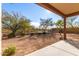 Desert landscape with covered patio and fenced yard at 29715 N 119Th Ln, Peoria, AZ 85383