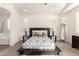 Bright bedroom with king-size bed and ensuite bathroom at 29715 N 119Th Ln, Peoria, AZ 85383