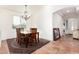 Dining area with a chandelier, wood table, and four chairs at 29715 N 119Th Ln, Peoria, AZ 85383