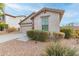 Home's exterior with a two-car garage and well-maintained landscaping at 29715 N 119Th Ln, Peoria, AZ 85383