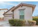 House exterior showcasing a two-car garage and landscaping at 29715 N 119Th Ln, Peoria, AZ 85383
