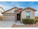 One-story home with stone accents and a two-car garage at 29715 N 119Th Ln, Peoria, AZ 85383