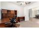 Home office with large desk and view into dining area at 29715 N 119Th Ln, Peoria, AZ 85383