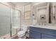 Modern bathroom with a walk-in shower and a blue vanity at 2995 N 165Th Ln, Goodyear, AZ 85395