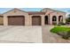 Beautiful two-story home with a three-car garage and landscaped front yard at 2995 N 165Th Ln, Goodyear, AZ 85395