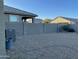Backyard with gravel landscaping, block wall, and AC unit at 35262 W San Ildefanso Ave, Maricopa, AZ 85138