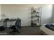 Bedroom with desk, chair, and shelving unit at 35262 W San Ildefanso Ave, Maricopa, AZ 85138