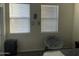 Bedroom with double bed, chair, and two windows at 35262 W San Ildefanso Ave, Maricopa, AZ 85138
