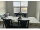 Dining area with table and chairs, featuring a large window at 35262 W San Ildefanso Ave, Maricopa, AZ 85138