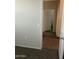 Carpeted hallway with doors to bedrooms and bath at 35262 W San Ildefanso Ave, Maricopa, AZ 85138