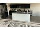 Kitchen with island, dark cabinets, and granite counters at 35262 W San Ildefanso Ave, Maricopa, AZ 85138