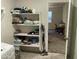 Laundry room with shelving and view of office at 35262 W San Ildefanso Ave, Maricopa, AZ 85138