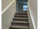 Carpeted staircase with white railing at 35262 W San Ildefanso Ave, Maricopa, AZ 85138