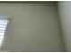 Close-up of a light-beige wall with small holes and marks at 35262 W San Ildefanso Ave, Maricopa, AZ 85138