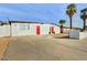 Front view of a remodeled mid-century home with red doors and gravel landscaping at 3538 W Chambers St, Phoenix, AZ 85041