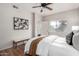 A cozy bedroom with a ceiling fan, wood floors, a queen size bed, and a window that provides natural light at 3830 E Lakewood E Pkwy # 2154, Phoenix, AZ 85048
