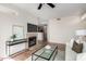 Bright living room boasts a fireplace, and comfortable seating arrangements with view into kitchen at 3830 E Lakewood E Pkwy # 2154, Phoenix, AZ 85048