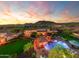 Sunset view of a luxury home with a large pool and expansive backyard at 4090 E Galvin St, Cave Creek, AZ 85331