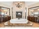 Luxurious bathroom with a large soaking tub, double vanity, and fireplace at 4090 E Galvin St, Cave Creek, AZ 85331