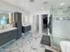 Spa-like bathroom featuring a walk-in shower, double vanity, and marble flooring at 4121 W Alta Vista Rd, Phoenix, AZ 85041