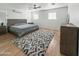Main bedroom with a king-size bed and gray area rug at 4121 W Alta Vista Rd, Phoenix, AZ 85041