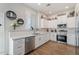 Modern kitchen with white cabinets, stainless steel appliances, and quartz countertops at 4807 W St Kateri Dr, Laveen, AZ 85339