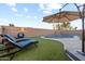 Inviting pool area with lounge chairs and a large umbrella at 4807 W St Kateri Dr, Laveen, AZ 85339