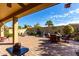 Landscaped backyard with seating and fountain at 5399 N Comanche Dr, Eloy, AZ 85131