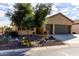 House exterior with a three-car garage and drought-tolerant landscaping at 5399 N Comanche Dr, Eloy, AZ 85131