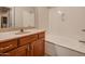 Clean bathroom with a tub and wood vanity at 5450 E Deer Valley Dr # 4201, Phoenix, AZ 85054