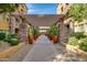 Inviting walkway with stone pillars, lush landscaping, and a pergola at 5450 E Deer Valley Dr # 4201, Phoenix, AZ 85054